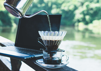 Close Up drip coffee maker with hot smoke from a pot,Morning coffee time with notebook...