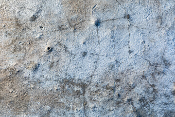 Detailed surface patterns and textures of grey concrete wall close up. Grunge background with copy space.