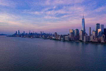 Aerial view of low Manhattan, new york at beautiful cloudy dusk from Hudson river