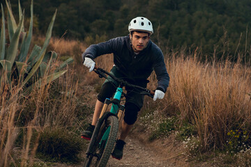 Cyclist boy going down the track on an enduro mountain bike in Barcelona