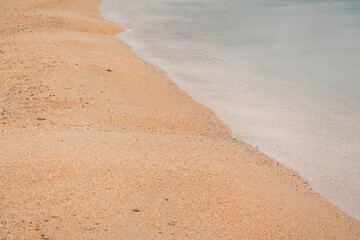 sand and smooth the surface of the water is diagonal in the photo.