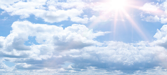Naklejka na ściany i meble Hot cloudy summer background banner panorama - Blue sky with clouds and glowing sun