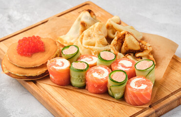 Russian pancakes with salmon and red caviar