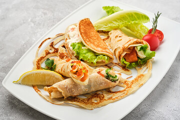 Russian pancakes with salmon and red caviar