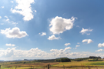 Agriculture fields and cumulonimbus clouds on blue sky