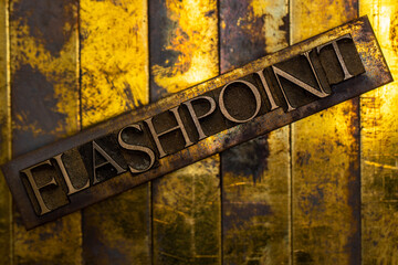 Flashpoint text formed with real authentic typeset letters on vintage textured silver grunge copper and gold background
