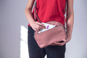 woman hand menstrual pad in bag
