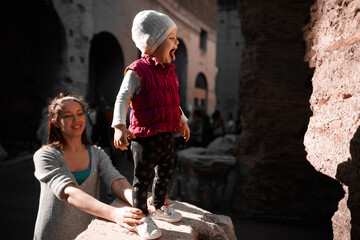 little girl shows her tongue at the Colosseum