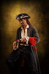 Fototapeta premium Portrait of a pirate in profile, drinking rum sitting in a tavern