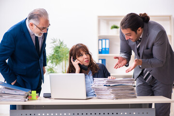 Two male and one female employees working in the office