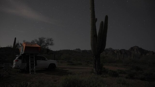 Stars moving across the sky with a truck and rooftop tent camping.