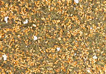 Japanese green tea Genmaicha. Tea leaves with roasted brown rice. Organic tea background. Top view....