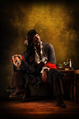 Fototapeta na wymiar Portrait of a pirate drinking rum, sitting in a tavern