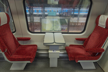 Electric multiple unit interior with red seat in first class coach