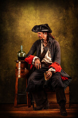 Fototapeta na wymiar Portrait of a pirate drinking rum, sitting in a tavern