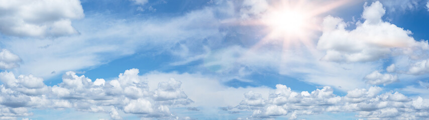 Hot cloudy summer background banner panorama - Blue sky with clouds and glowing sun