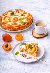Apricot mascarpone tart, on blue background.