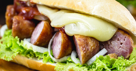 Brazilian beef sandwich, sausage, tomato, lettuce and onion in a salt bread.