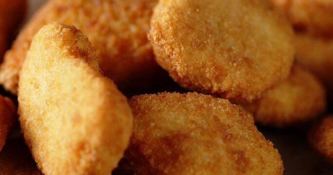 A pile of chicken nuggets rotates slowly.