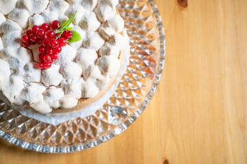 red currant meringue cake on a wooden table