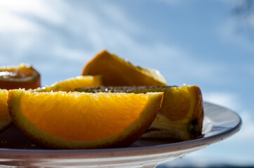 Naklejka na ściany i meble orange slices on plate in easter sunlight