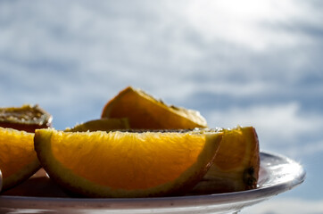 Fototapeta na wymiar orange slices on plate in easter sunlight