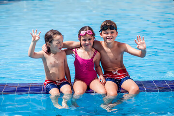 Kids playing in the swimming pool. Childhood, summer and vacation concept