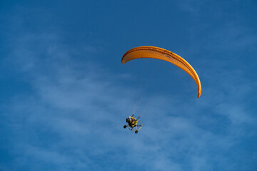Paramotor flying in the blue sky, extreme sports