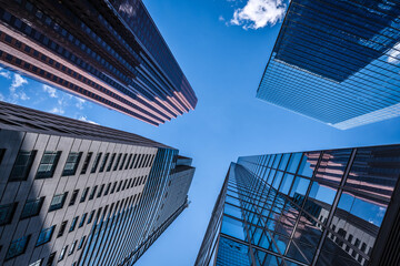 Business and finance concept, looking up at modern office building architecture in the financial...