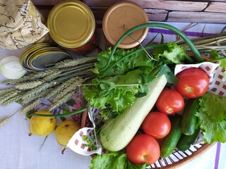 Still life in the kitchen vegetables zucchini cucumbers tomatoes onion salad fruit yellow pear on the table near the brick wall