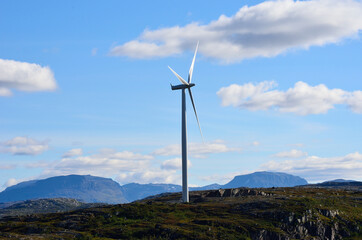 windmill on mountain top on blue sunny autumn sky