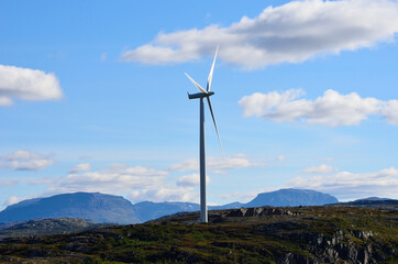 windmill on mountain top on blue sunny autumn sky
