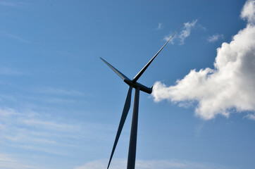 windmill on blue sky background with some clouds