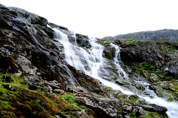 clean fresh water stream running down mountain side in summer landscape