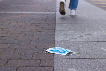 steps away from a surgical mask lying on the floor.