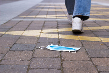 steps away from a surgical mask lying on the floor.