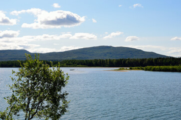 mighty tall mountain, blue summer sky and sea water landscape in summer