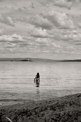 A woman harvesting from the sea. 