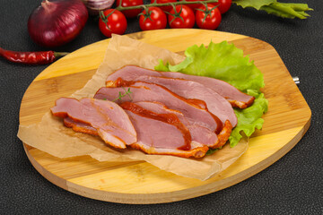 Sliced smoked duck breast served salad