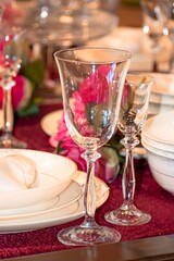 Decorated dining table with champagne glasses and a bouquet of artificial flowers