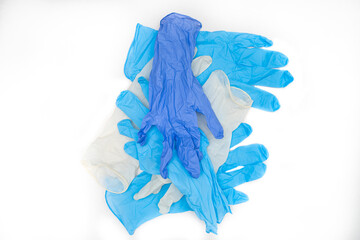  many protective disposable latex gloves laying on white background