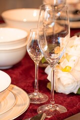 Decorated dining table with champagne glasses and a bouquet of artificial flowers
