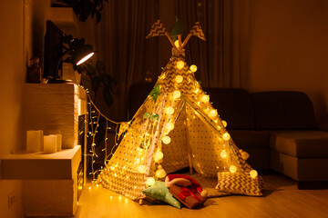 Christmas with gifts near a wigwam and a fireplace © Angelov