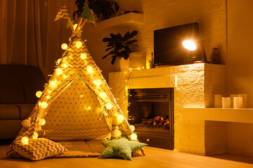 Christmas with gifts near a wigwam and a fireplace © Angelov