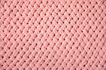 Texture of pink big knit blanket. Large knitting plaid