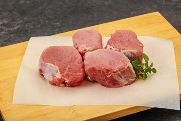 Raw pork medallion served rosemary