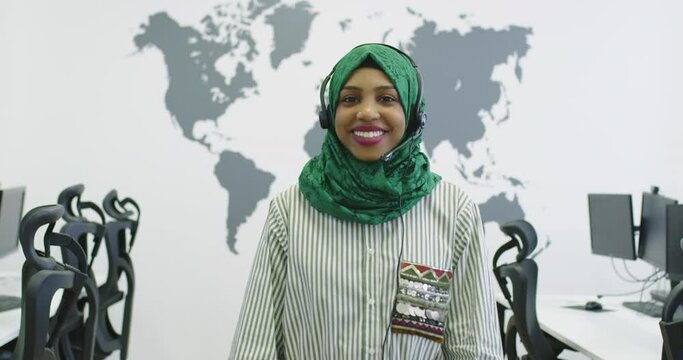 Muslim female with hijab scarf customer representative business woman with phone headset helping and supporting online with customer in modern bright call center