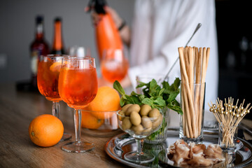 two beautiful glasses of cold bright orange drink stand on the table