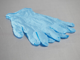 Blue medical gloves on a gray background