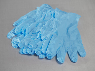 Blue medical gloves on a gray background